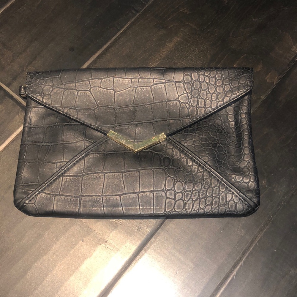 Black clutch, envelope style with gold accent.  Great condition